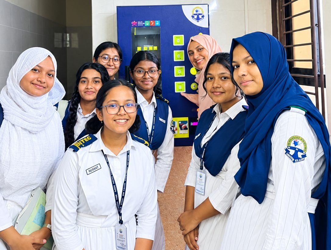 Students in Bangladesh gathered beside a Shapla Wellbeing pad vending machine at their school