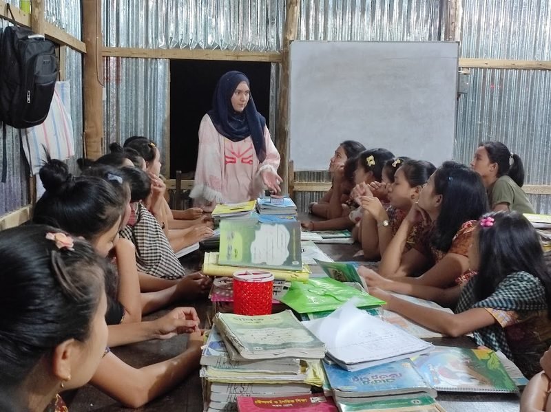 A facilitator leading a menstrual health session with girls in a rural classroom in Bangladesh